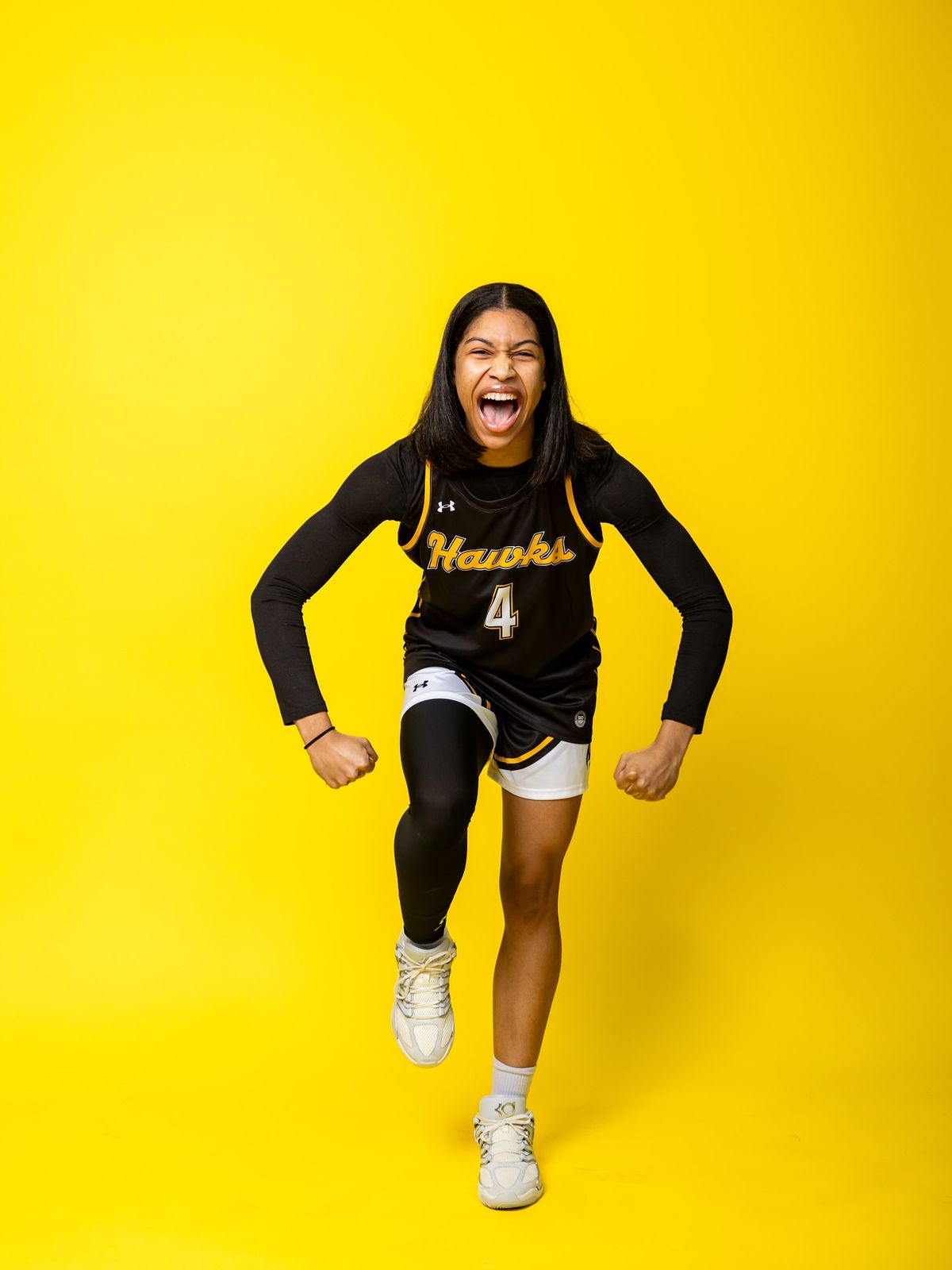 Basketball player celebrating on a yellow backdrop
