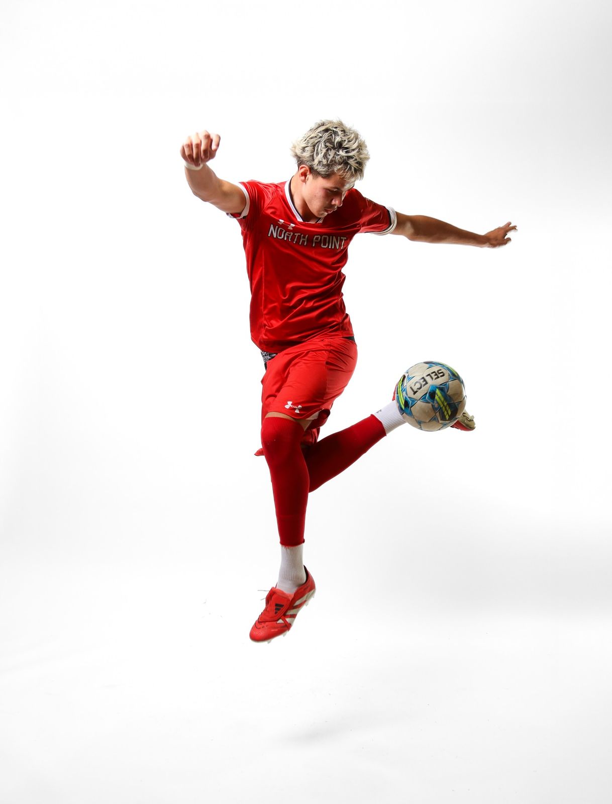 Soccer player mid-air juggling the ball